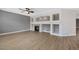 Living room featuring hardwood floors, neutral walls, fireplace, open floor plan and a ceiling fan at 5531 Fox Meadow Ave, Highlands Ranch, CO 80130