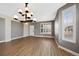 Bright living room featuring wood floors, a contemporary light fixture, and large windows at 5531 Fox Meadow Ave, Highlands Ranch, CO 80130
