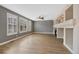 Bright living room with hardwood floors, fireplace, large windows, and natural light at 5531 Fox Meadow Ave, Highlands Ranch, CO 80130