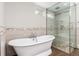 Bathroom featuring a freestanding tub, seamless glass shower and modern finishes at 5743 Field St, Arvada, CO 80002