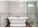 Luxurious bathroom featuring a freestanding tub, glass-enclosed shower, and elegant tile work for a spa-like retreat at 5743 Field St, Arvada, CO 80002