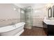 Modern bathroom with soaking tub, walk-in shower, and stylish tile work at 5743 Field St, Arvada, CO 80002