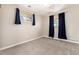 Cozy bedroom with neutral walls, plush carpeting, and bright windows dressed with elegant blue drapes at 5743 Field St, Arvada, CO 80002