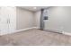 Neutral bedroom with carpeted floor, closet with double doors, baseboard heating and a window with grey curtains at 5743 Field St, Arvada, CO 80002