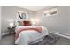 A cozy bedroom includes soft carpeting, a bright window, and a comfortable queen-sized bed at 5743 Field St, Arvada, CO 80002