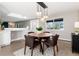 The dining room features a modern light fixture, a window, and access to the kitchen and living areas at 5743 Field St, Arvada, CO 80002
