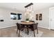 This open dining area features modern lighting, a stylish rug, and an exterior-view window at 5743 Field St, Arvada, CO 80002