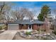 Charming brick home with landscaped front yard, mature trees and a two-car garage at 5743 Field St, Arvada, CO 80002