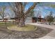 Well-maintained brick home boasts mature trees, professional landscaping, and a charming front porch at 5743 Field St, Arvada, CO 80002