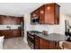 Modern kitchen featuring stainless steel appliances, wooden cabinets, granite countertops, and a breakfast bar for casual dining at 5743 Field St, Arvada, CO 80002