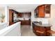 This kitchen features sleek wooden cabinetry, stainless steel appliances, and a breakfast bar for a modern, functional space at 5743 Field St, Arvada, CO 80002