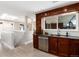 This modern kitchen features wood cabinets, stainless steel appliances, and a large window above the sink for ample natural light at 5743 Field St, Arvada, CO 80002