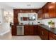 An updated kitchen features a window over the sink and dark cabinetry with glass-door display cabinets at 5743 Field St, Arvada, CO 80002