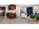 Open concept living room featuring a cozy fireplace, modern furnishings, and a breakfast bar with barstool seating at 5743 Field St, Arvada, CO 80002