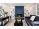 Inviting living room features a striking blue brick fireplace flanked by built-in shelves, providing a cozy and stylish ambiance at 5743 Field St, Arvada, CO 80002