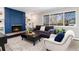 The living room is warm and inviting with a blue brick fireplace, plush seating, and plenty of natural light at 5743 Field St, Arvada, CO 80002