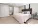 Serene main bedroom boasts neutral tones, built-in storage, and an ensuite bathroom visible through a doorway at 5743 Field St, Arvada, CO 80002