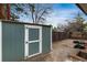 Outdoor storage shed painted in a neutral color with a white trim, plus some yard tools at 5743 Field St, Arvada, CO 80002