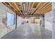 Bright, unfinished basement with white-wrapped walls, concrete flooring, and exposed ceiling, offering potential for customization at 10344 Vienna St, Parker, CO 80134