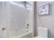 Clean bathroom with a tiled shower, tub combo, and natural light at 10344 Vienna St, Parker, CO 80134