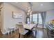 Bright dining room featuring a modern chandelier, stylish chairs, and a marble-topped table on hardwood floors at 10344 Vienna St, Parker, CO 80134