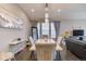 Elegant dining area with modern lighting, neutral walls, and hardwood floors at 10344 Vienna St, Parker, CO 80134