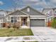 Charming single Gathering home with stone accents, a two car garage, and professional landscaping at 10344 Vienna St, Parker, CO 80134