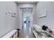 Bright hallway featuring hardwood floors, neutral paint and decor with shoe storage at 10344 Vienna St, Parker, CO 80134