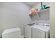 Functional laundry room equipped with modern washer, dryer, and ample shelving at 10344 Vienna St, Parker, CO 80134