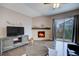 Bright Gathering room with a fireplace, media center, and hardwood floors at 10344 Vienna St, Parker, CO 80134