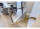 View of the staircase leading down to the basement with light-colored carpet and a living room visible on the main level at 10344 Vienna St, Parker, CO 80134