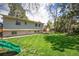 Large backyard with well-maintained lawn and a charming two-story home at 7773 Brentwood Ct, Arvada, CO 80005