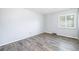 Bright bedroom with neutral walls, wood-look floors, and a large window with natural light at 7773 Brentwood Ct, Arvada, CO 80005
