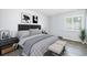 Cozy bedroom featuring a comfortable bed with stylish bedding and decorative accents and a window at 7773 Brentwood Ct, Arvada, CO 80005