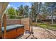 Relax in this outdoor hot tub with privacy screen and lighting, surrounded by mature trees at 7773 Brentwood Ct, Arvada, CO 80005