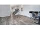Open-concept living room with hardwood floors, stairway, and computer desk at 7773 Brentwood Ct, Arvada, CO 80005