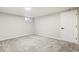 Finished basement with comfortable carpet and a door that leads to additional space at 423 Nile St, Aurora, CO 80010