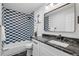 Updated bathroom featuring modern vanity and blue patterned tile in the shower at 423 Nile St, Aurora, CO 80010