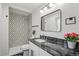 Bathroom featuring a modern vanity and patterned shower tile at 423 Nile St, Aurora, CO 80010