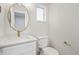 Stylish bathroom with a modern vanity, gold fixtures, and a toilet at 423 Nile St, Aurora, CO 80010
