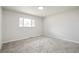 Bright bedroom with plush carpet and a window allowing natural light at 423 Nile St, Aurora, CO 80010