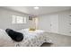 Bright bedroom with neutral color palette, window views, and plush carpeting at 423 Nile St, Aurora, CO 80010
