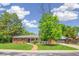 Charming ranch-style home with brick accents, lush lawn, and a brick walkway leading to the front door at 423 Nile St, Aurora, CO 80010