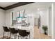 Modern kitchen featuring a breakfast bar, stainless steel appliances, and black and white backsplash at 423 Nile St, Aurora, CO 80010