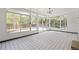 Bright sunroom with black and white tile flooring and large windows at 423 Nile St, Aurora, CO 80010