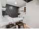 Stylish wet bar area featuring white cabinets, marble counters, and unique textured wall design at 423 Nile St, Aurora, CO 80010