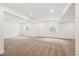 Spacious finished basement featuring soft carpeting, neutral paint and base trim, and two egress windows at 5614 Riverbend Ave, Firestone, CO 80504