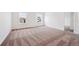 Large bedroom with neutral carpet, two windows, and ample space for relaxation and personalization at 5614 Riverbend Ave, Firestone, CO 80504