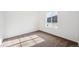 Bedroom with neutral carpeting, white walls, base trim, and a large window offering natural light at 5614 Riverbend Ave, Firestone, CO 80504