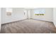 Expansive bedroom with large windows offering views, neutral walls, and base trim with soft carpeting at 5614 Riverbend Ave, Firestone, CO 80504